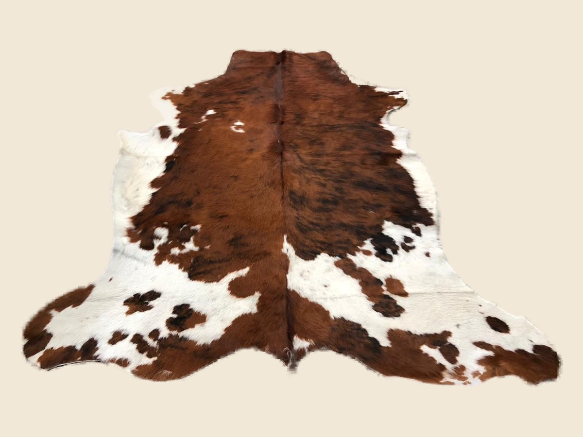 Brown and white cowhide rug