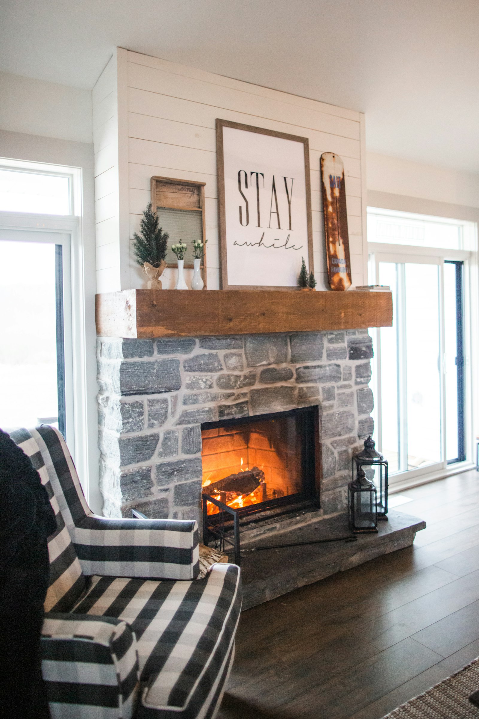 Stone fireplace with a lit fire - Gallery Art Group