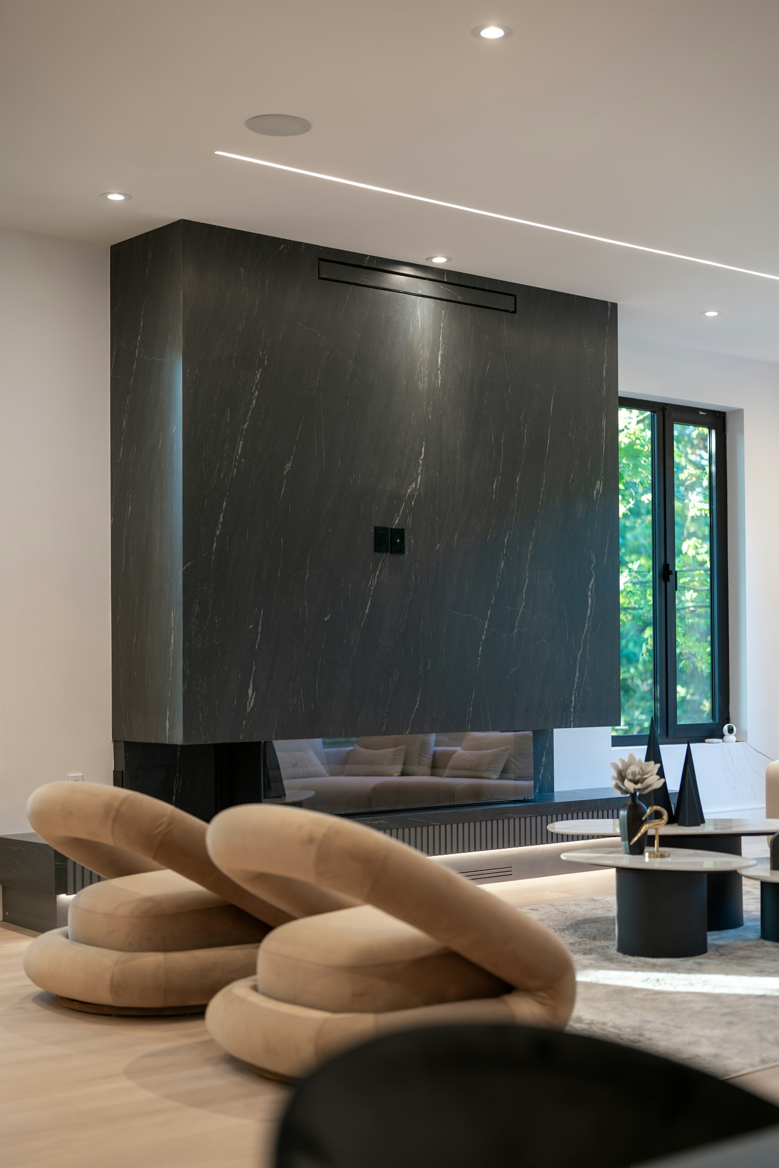 Dark marble fireplace with chairs - Gallery Art Group