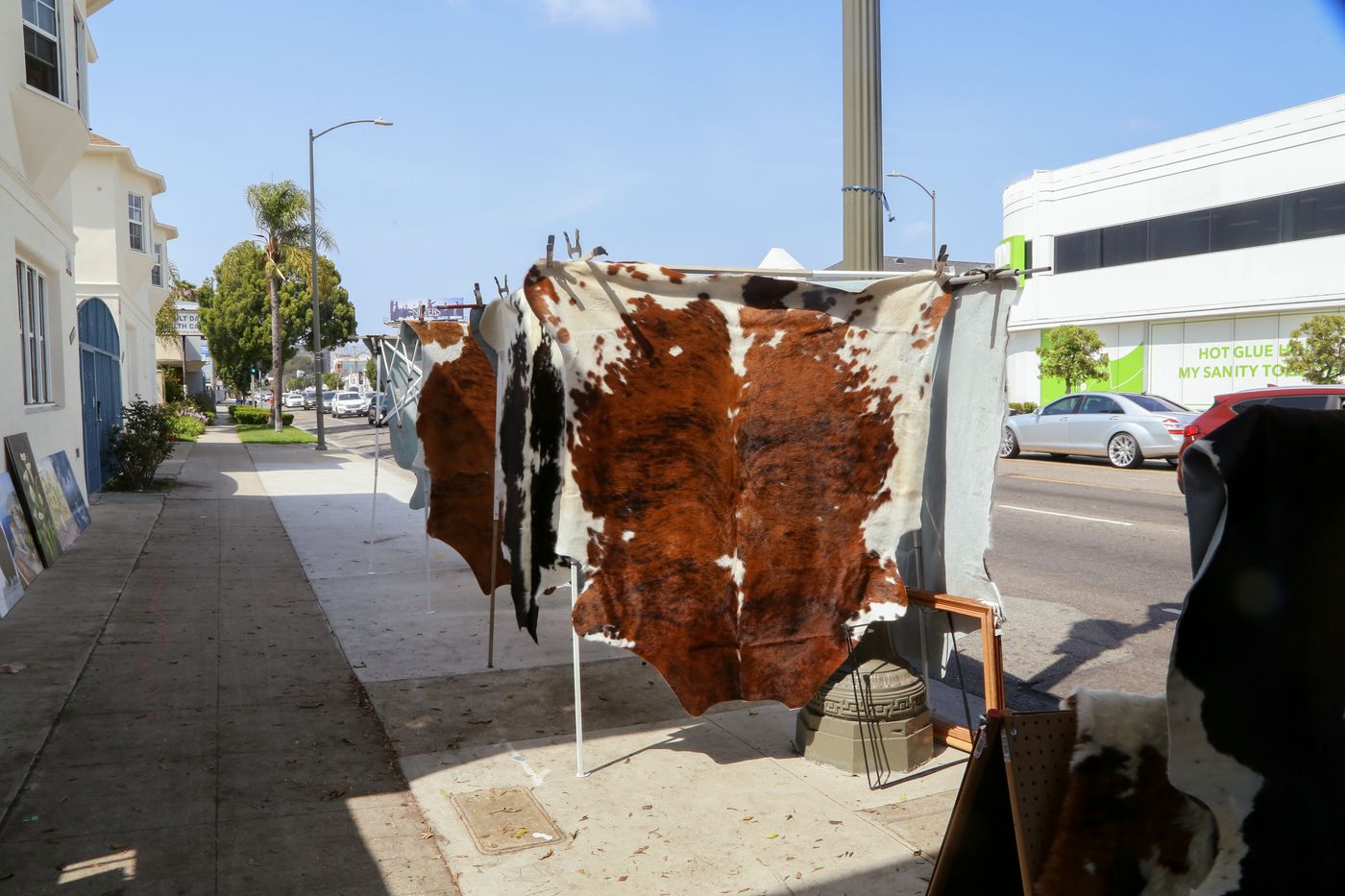Cowhides hanging outside the Los Angeles sidewalk store