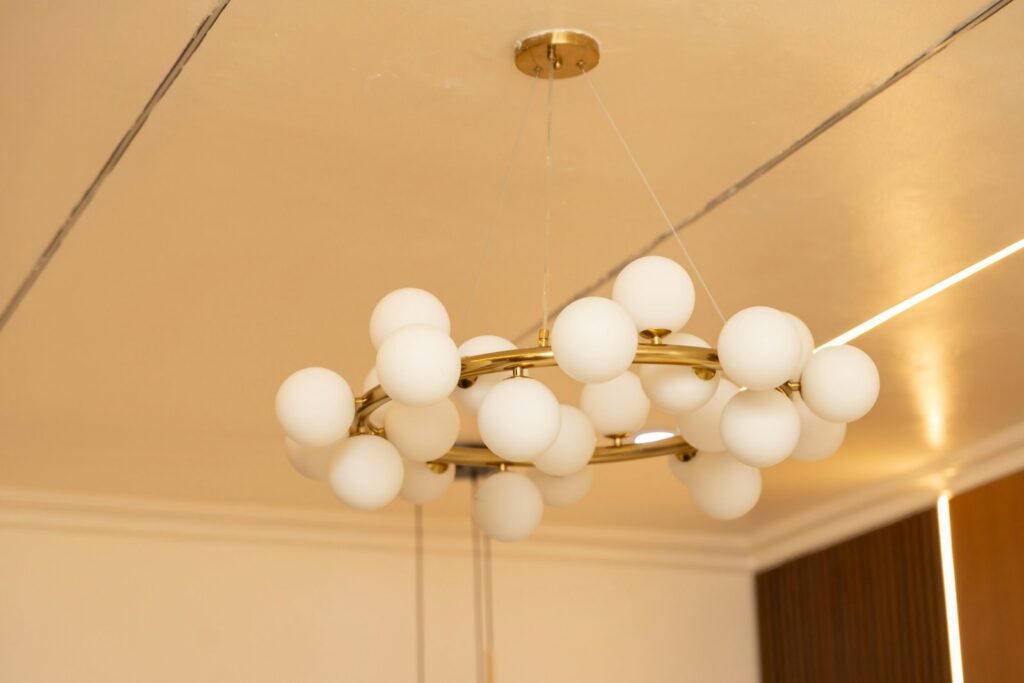 Gold chandelier with white globe lights