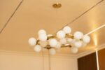 Gold chandelier with white globe lights