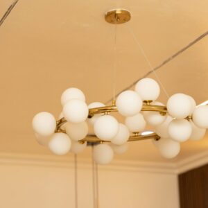 Gold chandelier with white globe lights