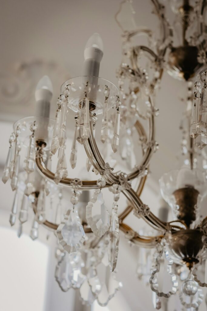 Glass chandelier lit in a room
