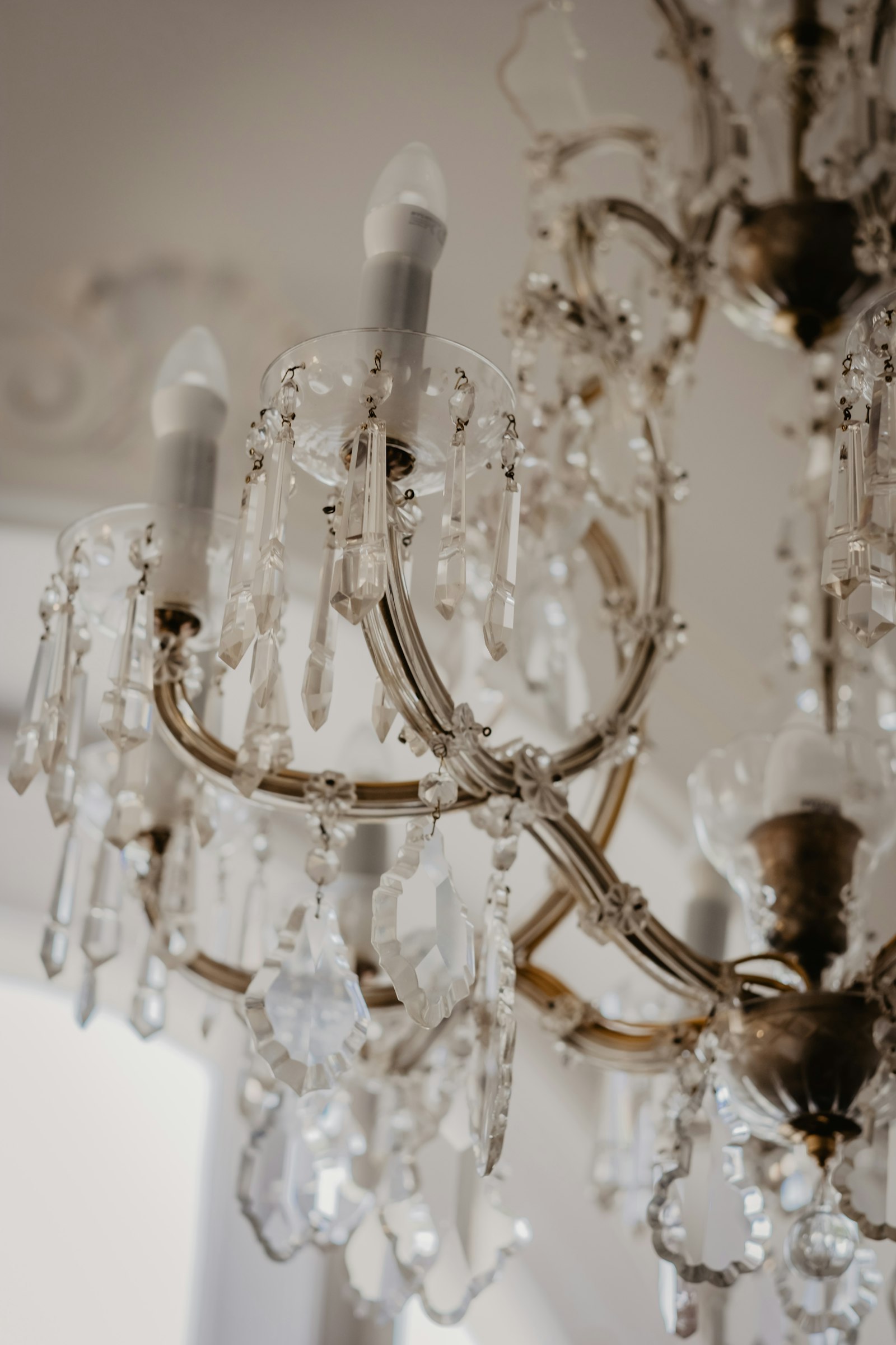 Glass chandelier lit in a room