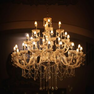 Brass chandelier lit in a room