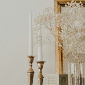 Brass candlesticks with white tapers