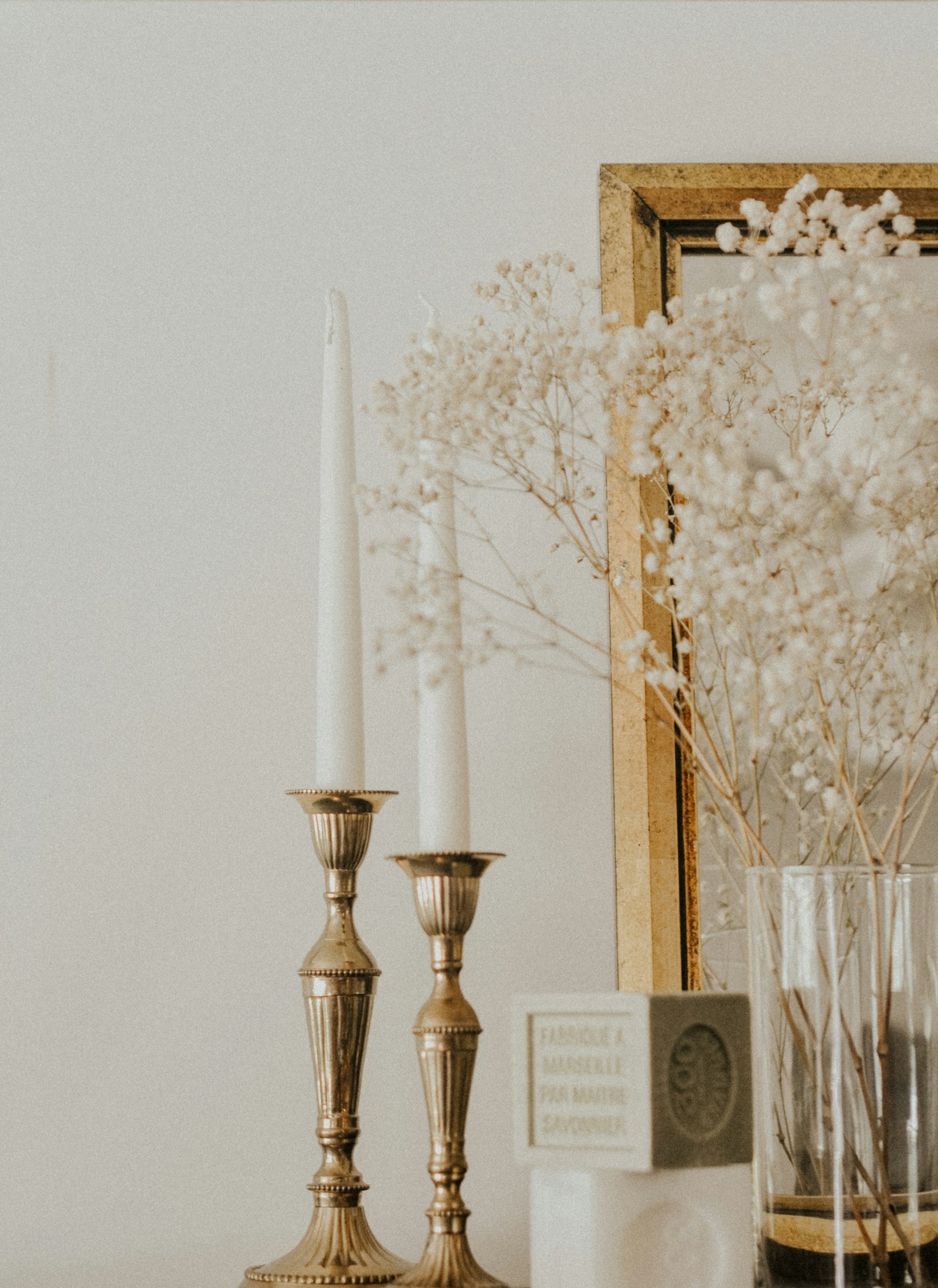 Brass candlesticks with white tapers