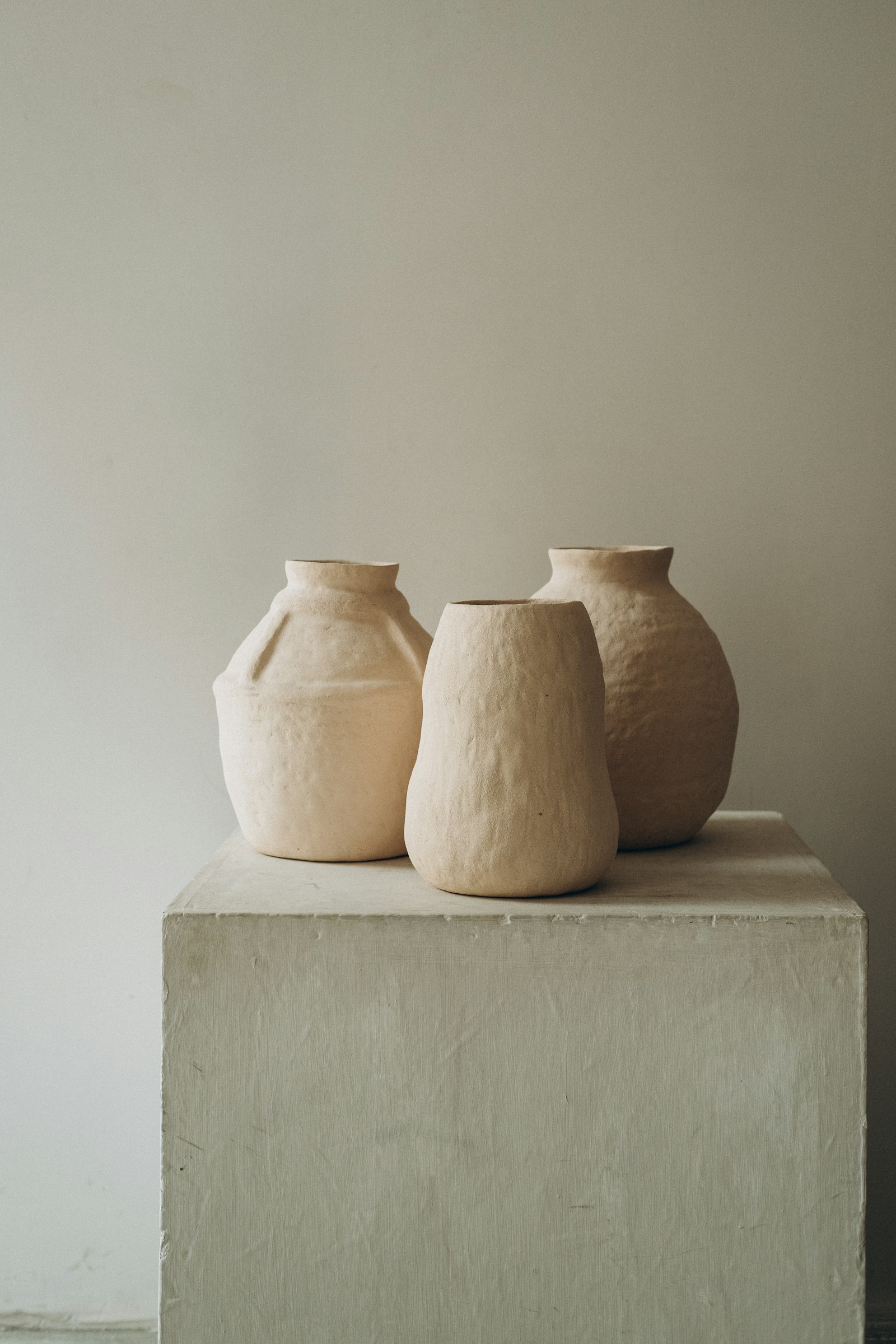 Three clay vessels on a plinth Three clay vessels on a plinth