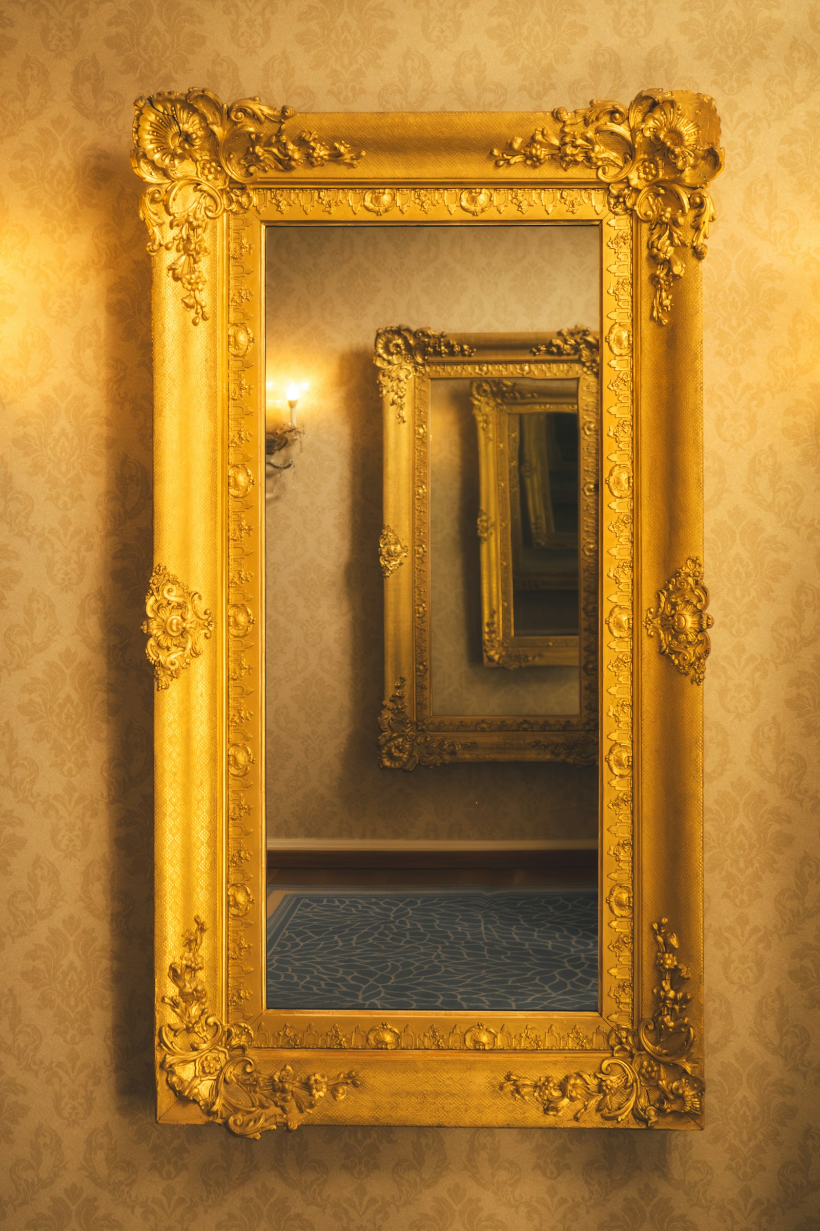 Gold framed mirror on a wall Gold framed mirror on a wall