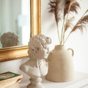 Classical bust beside a vase