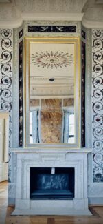 Ornate marble fireplace with mirror