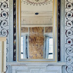 Ornate marble fireplace with mirror