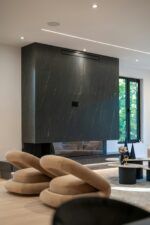Dark marble fireplace with chairs